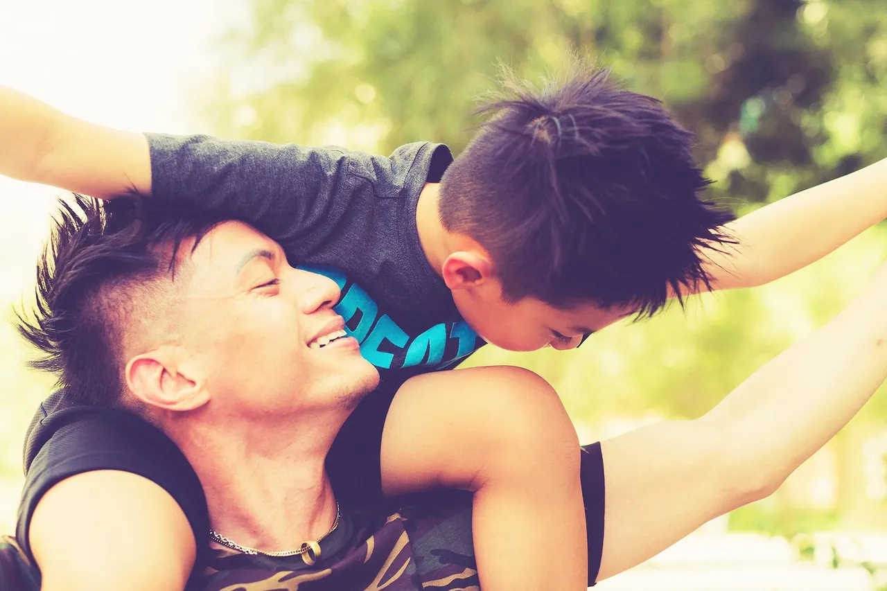 Two friends sharing a playful moment outdoors, photographed by GCShutter