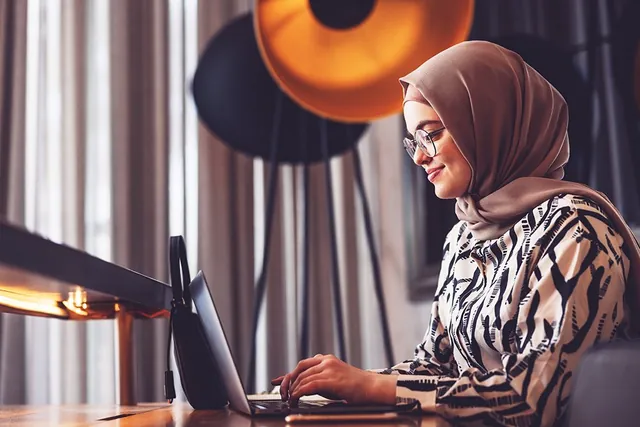 Woman working on a laptop at home, photographed by GCShutter