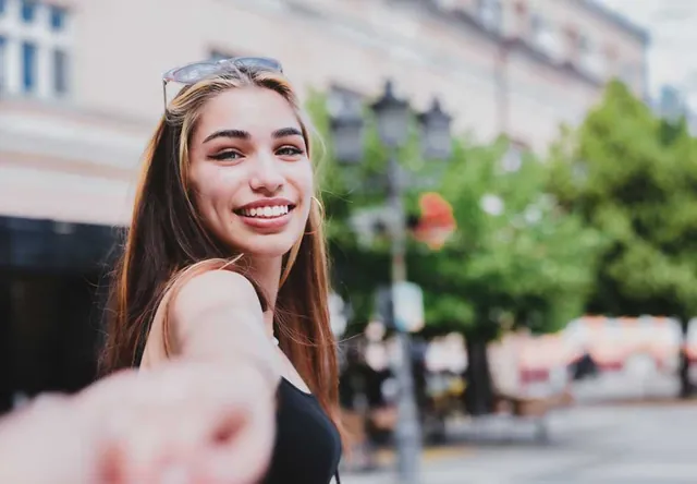 Young woman taking a selfie in the city, photographed by GCShutter